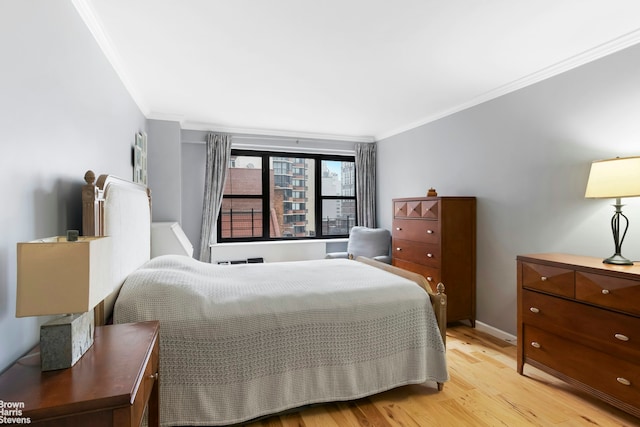 340 E 74th St Unit 9G, New York City, NY 10021 - bedroom featuring crown molding and light wood-type flooring