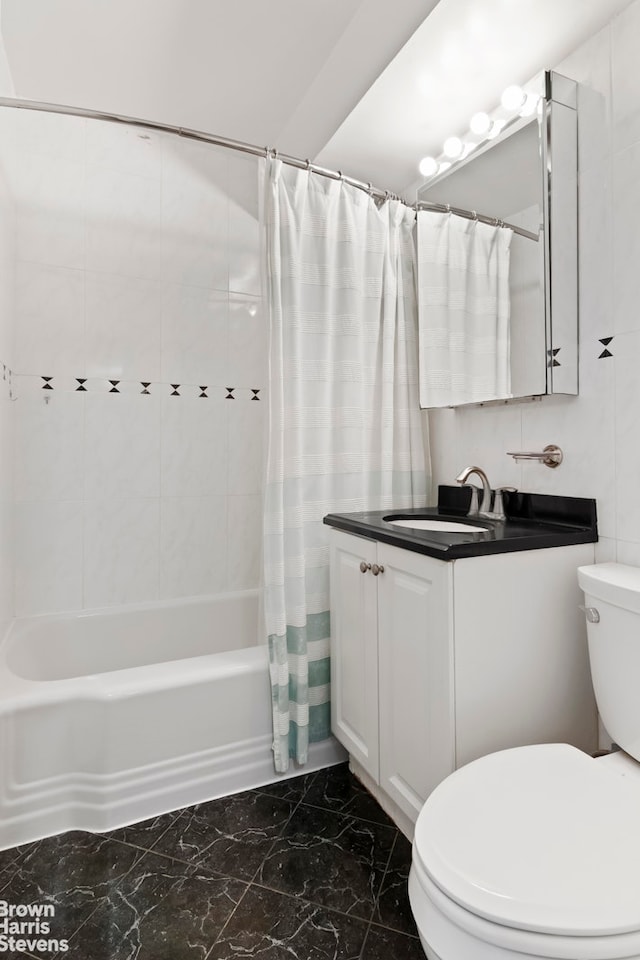 340 E 74th St Unit 9G, New York City, NY 10021 - bathroom featuring marble look tile flooring, shower / bath combo, and vanity