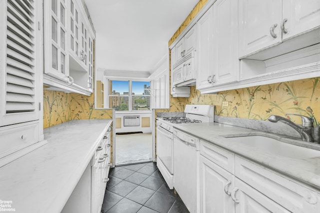 1175 York Ave Unit Phb4, New York City, NY 10065 - kitchen with white appliances, white cabinets, dark tile patterned flooring, glass insert cabinets, and light stone counters
