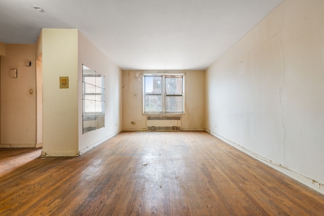67-30 Clyde St Unit 5R, New York City, NY 11375 - spare room with radiator heating unit and hardwood / wood-style floors