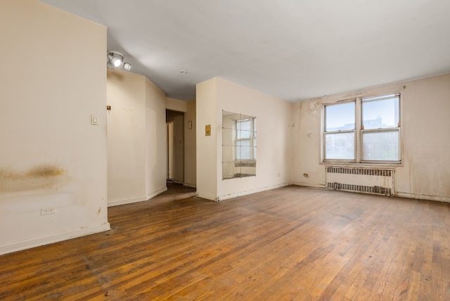 67-30 Clyde St Unit 5R, New York City, NY 11375 - unfurnished room with radiator heating unit and wood-type flooring