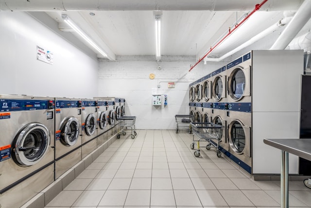 67-30 Clyde St Unit 5R, New York City, NY 11375 - community laundry with washing machine and clothes dryer and light tile patterned floors