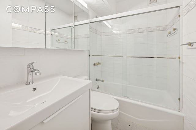 211 E 53rd St Unit 7C, New York City, NY 10022 - bathroom with tile walls, combined bath / shower with glass door, and vanity
