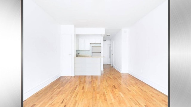 1628 2nd Ave Unit 2B, New York City, NY 10028 - unfurnished living room with light wood finished floors and baseboards