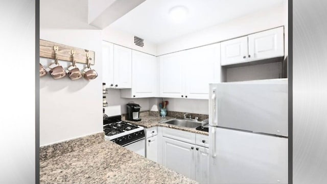 1628 2nd Ave Unit 2B, New York City, NY 10028 - kitchen featuring white appliances, white cabinets, and light stone countertops