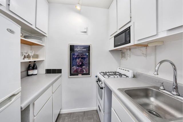 308 W 103rd St Unit 5C, New York City, NY 10025 - kitchen with gas range gas stove, fridge, black microwave, and white cabinetry