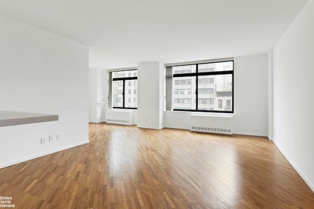 400 E 70th St Unit 503, New York City, NY 10021 - spare room with radiator and wood finished floors