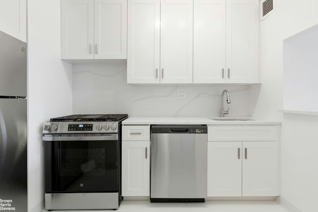 400 E 70th St Unit 503, New York City, NY 10021 - kitchen featuring appliances with stainless steel finishes, white cabinets, and light countertops