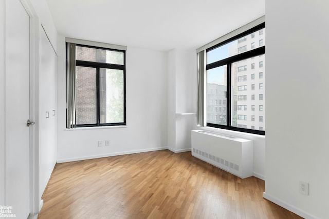 400 E 70th St Unit 503, New York City, NY 10021 - empty room with radiator heating unit and wood finished floors