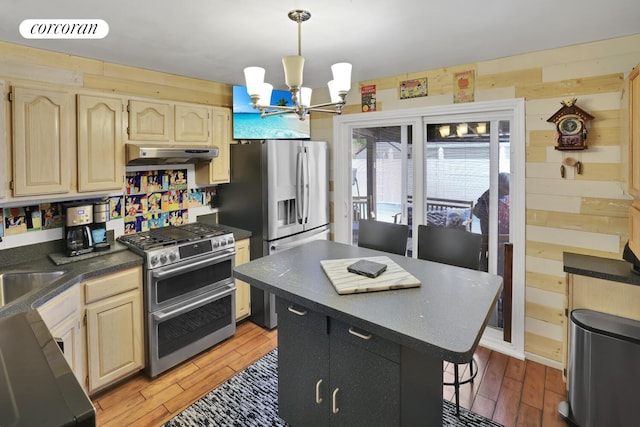 2054 Richmond Ave, New York City, NY 10314 - kitchen featuring appliances with stainless steel finishes, a chandelier, dark countertops, under cabinet range hood, and wooden walls