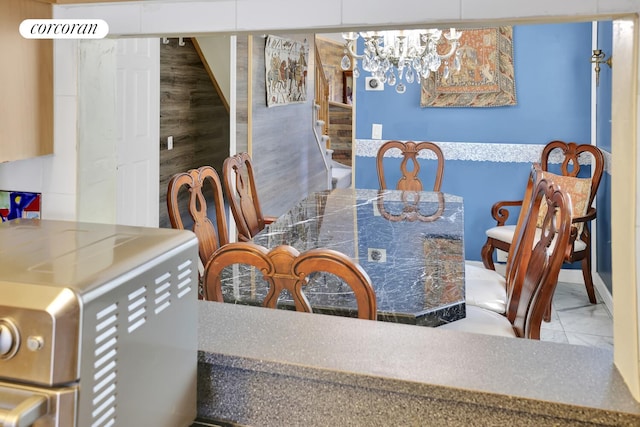 2054 Richmond Ave, New York City, NY 10314 - dining space with stairs, marble look tiles, and a chandelier