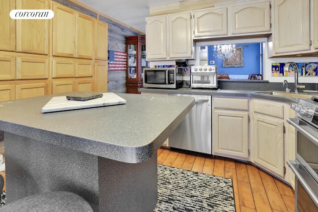 2054 Richmond Ave, New York City, NY 10314 - kitchen featuring appliances with stainless steel finishes, light wood-style floors, a kitchen island, and light brown cabinets