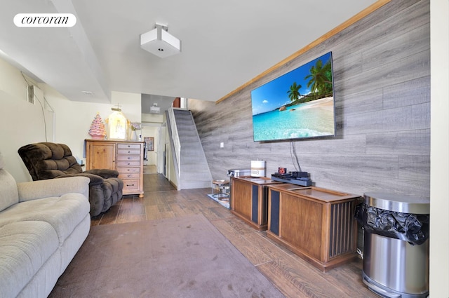 2054 Richmond Ave, New York City, NY 10314 - living room featuring an accent wall, wood finished floors, wooden walls, and stairs