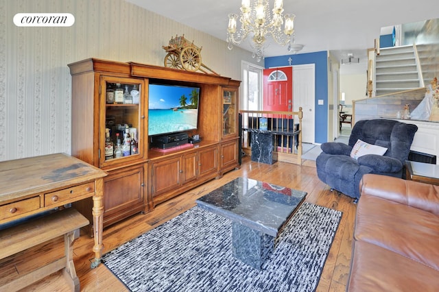 2054 Richmond Ave, New York City, NY 10314 - living area with a chandelier, light wood finished floors, wallpapered walls, and stairway
