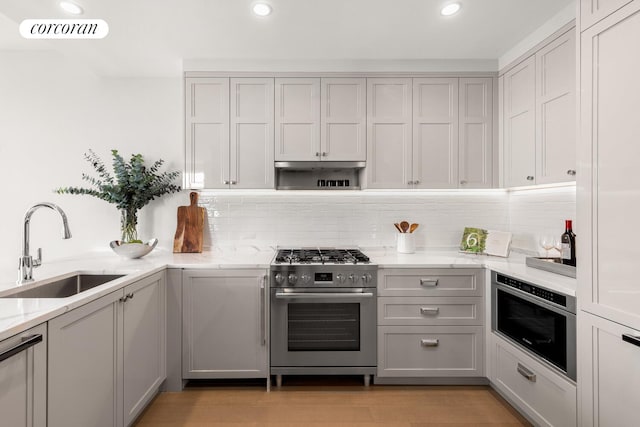 100 Claremont Ave Unit 17B, New York City, NY 10027 - kitchen with appliances with stainless steel finishes, light stone counters, tasteful backsplash, recessed lighting, and light wood-style floors