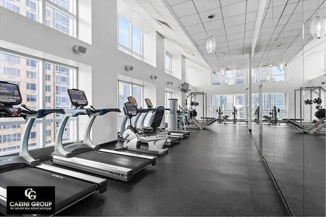 350 W 42nd St Unit 46E, New York City, NY 10036 - gym featuring a towering ceiling, healthy amount of natural light, and a paneled ceiling