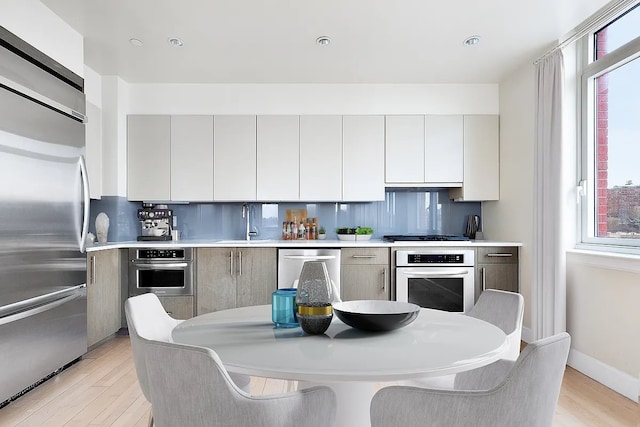 2300 Frederick Douglass Blvd Unit 11B, New York City, NY 10027 - kitchen with stainless steel appliances, light wood-style flooring, healthy amount of natural light, and recessed lighting