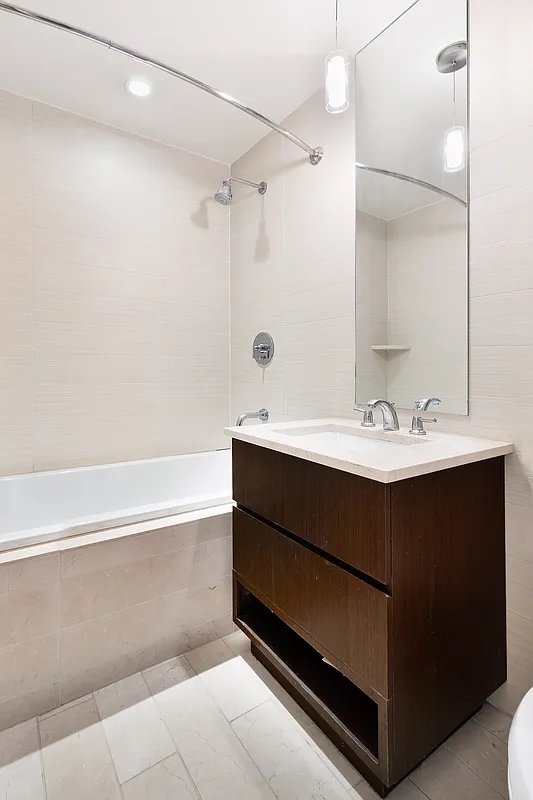 2300 Frederick Douglass Blvd Unit 11B, New York City, NY 10027 - full bath with tiled shower / bath combo, vanity, and tile patterned floors
