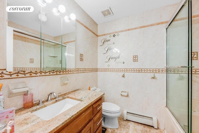 57 Bay 31st St Unit 3A, New York City, NY 11214 - bathroom with tile walls, a baseboard heating unit, vanity, and bath / shower combo with glass door