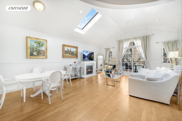 57 Bay 31st St Unit 3A, New York City, NY 11214 - living area featuring a skylight, light wood-style floors, a glass covered fireplace, and high vaulted ceiling