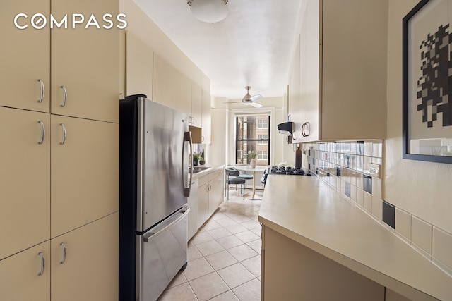710 W End Ave Unit 9A, New York City, NY 10025 - kitchen featuring freestanding refrigerator, light countertops, light tile patterned floors, ceiling fan, and cream cabinets