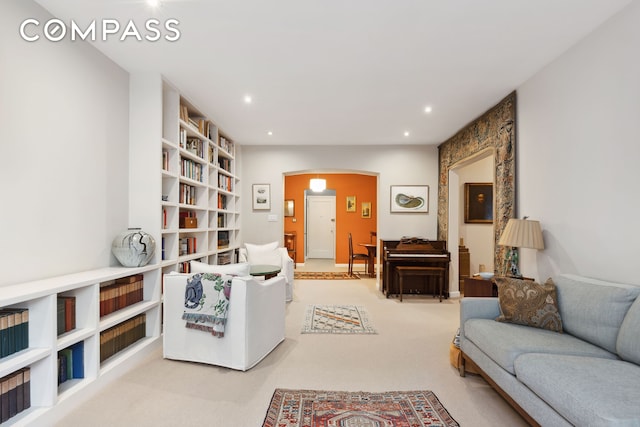 525 E 89th St Unit 4Hj, New York City, NY 10128 - living area with arched walkways, recessed lighting, light colored carpet, and built in shelves