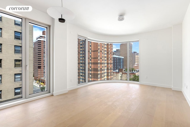 250 E 25th St Unit 9D, New York City, NY 10010 - spare room featuring wood finished floors and a city view