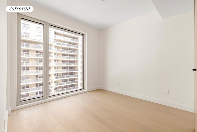 250 E 25th St Unit 9D, New York City, NY 10010 - spare room with light wood-type flooring and baseboards