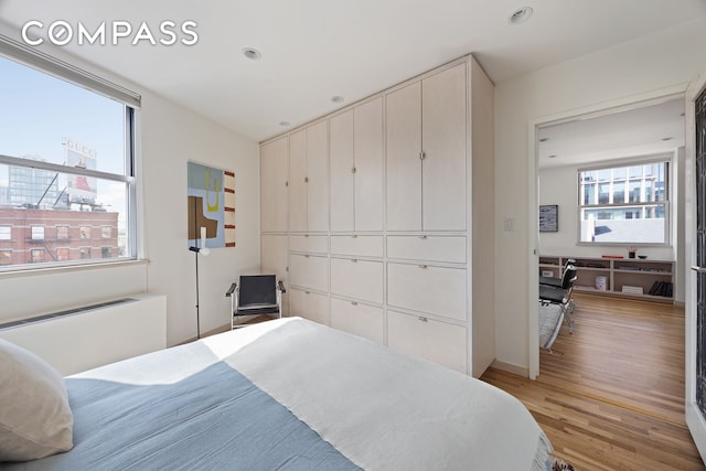 350 W 14th St Unit 6D, New York City, NY 10014 - bedroom featuring light wood-style flooring, recessed lighting, and a closet