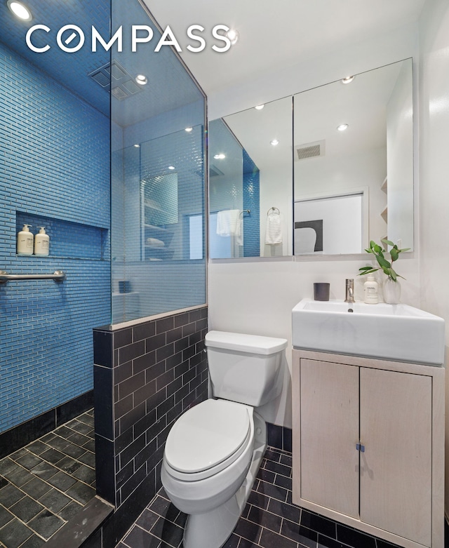 350 W 14th St Unit 6D, New York City, NY 10014 - full bathroom with tile patterned flooring, vanity, a walk in shower, and tile walls