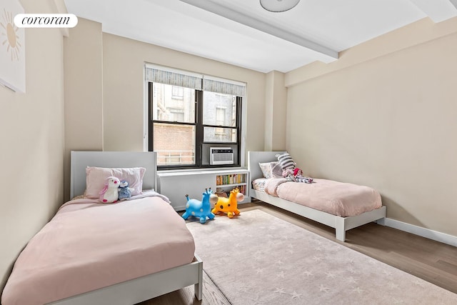 215 W 78th St Unit 2C, New York City, NY 10024 - bedroom with wood finished floors, beamed ceiling, and cooling unit