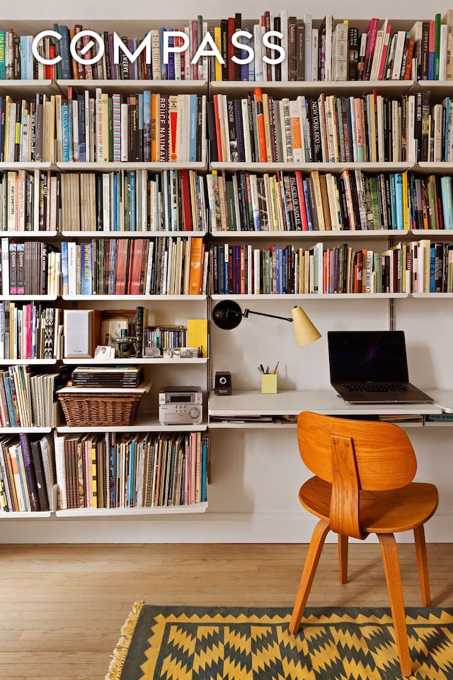 201 W 16th St Unit 9A, New York City, NY 10011 - living area featuring wood finished floors and bookshelves