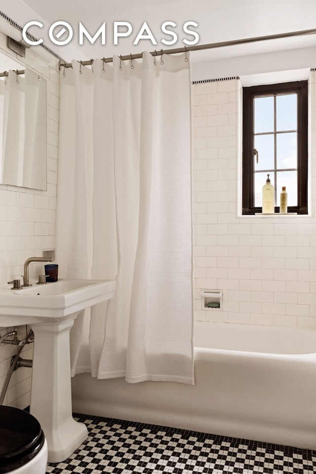201 W 16th St Unit 9A, New York City, NY 10011 - bathroom featuring shower / bath combo with shower curtain and tile patterned floors