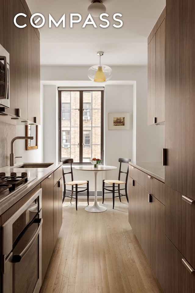 201 W 16th St Unit 9A, New York City, NY 10011 - kitchen with appliances with stainless steel finishes, modern cabinets, and light countertops