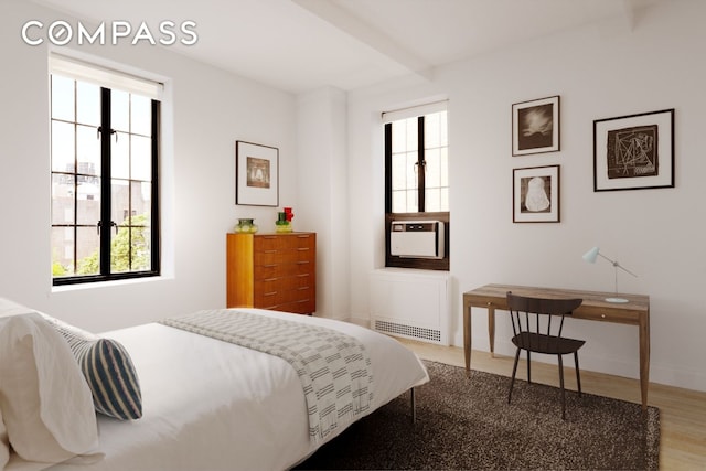 201 W 16th St Unit 9A, New York City, NY 10011 - bedroom with multiple windows, wood finished floors, and radiator