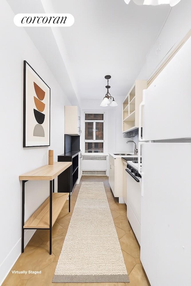 19 E 88th St Unit 4H, New York City, NY 10128 - kitchen featuring freestanding refrigerator, radiator, range, and white cabinetry
