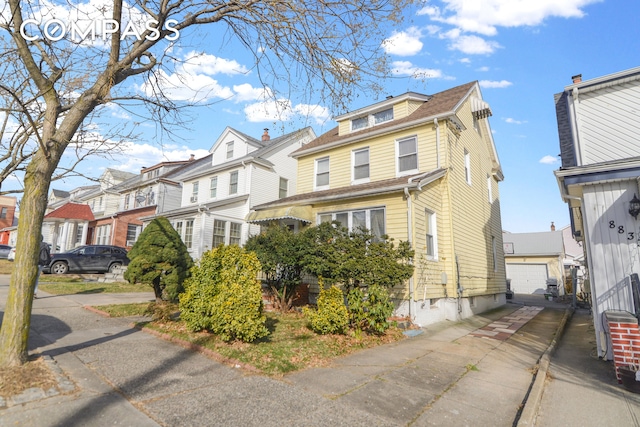 88-29 212th St, New York City, NY 11427 - view of front facade with a residential view and a detached garage