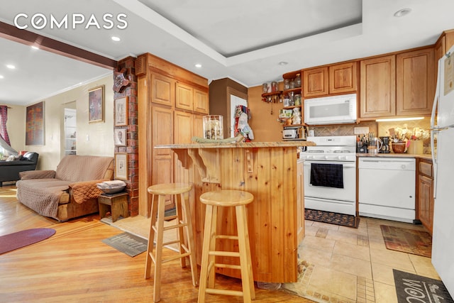 88-29 212th St, New York City, NY 11427 - kitchen featuring white appliances, recessed lighting, a kitchen breakfast bar, tasteful backsplash, and open floor plan