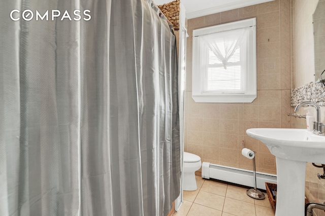 88-29 212th St, New York City, NY 11427 - full bathroom with a baseboard heating unit, tile patterned flooring, tile walls, and curtained shower