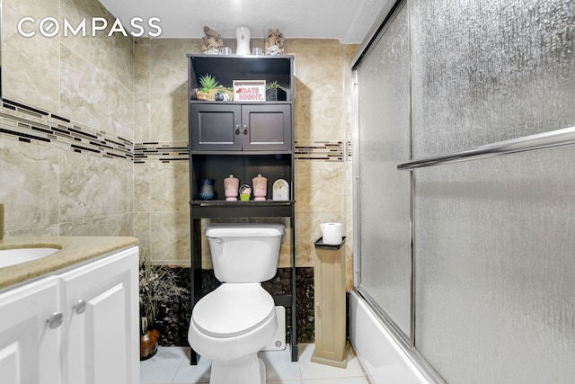 88-29 212th St, New York City, NY 11427 - bathroom featuring tile walls, vanity, tile patterned flooring, and combined bath / shower with glass door