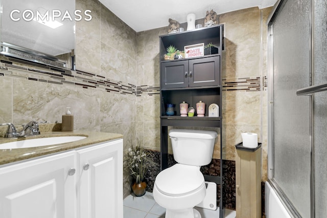 88-29 212th St, New York City, NY 11427 - full bathroom with tile walls, vanity, tile patterned floors, and combined bath / shower with glass door