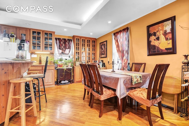 88-29 212th St, New York City, NY 11427 - dining area with a bar, light wood finished floors, recessed lighting, healthy amount of natural light, and a raised ceiling