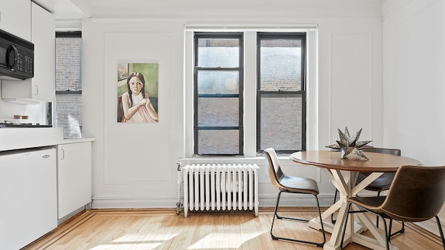 300 8th Ave Unit 3-I, New York City, NY 11215 - dining room with radiator heating unit and light wood-type flooring