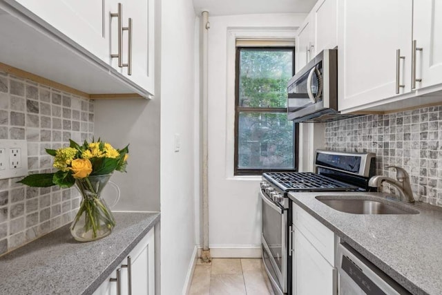 350 Cabrini Blvd Unit 1A, New York City, NY 10040 - kitchen with appliances with stainless steel finishes, tasteful backsplash, and white cabinetry