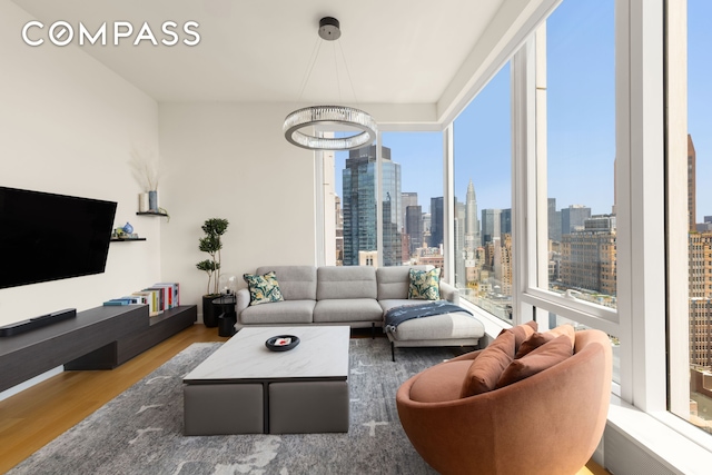 15 E 30th St Unit 30C, New York City, NY 10016 - living area featuring a skyline view and wood finished floors
