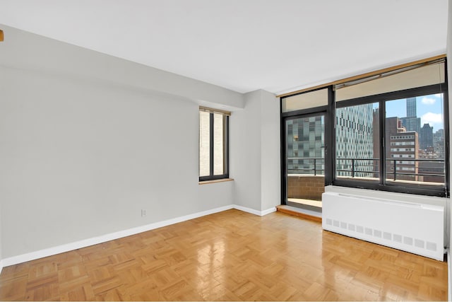 400 E 70th St Unit 1208, New York City, NY 10021 - spare room featuring radiator and a view of skyline