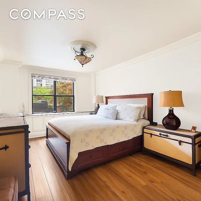 301 E 62nd St Unit 2K, New York City, NY 10065 - bedroom with ornamental molding and light wood finished floors