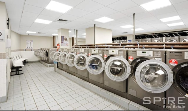 99 John St Unit 2201, New York City, NY 10038 - communal laundry room featuring tile patterned flooring and washer and dryer