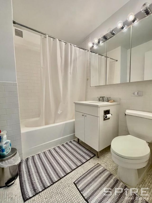 99 John St Unit 2201, New York City, NY 10038 - full bath featuring tile walls, shower / bath combo with shower curtain, vanity, and tile patterned floors