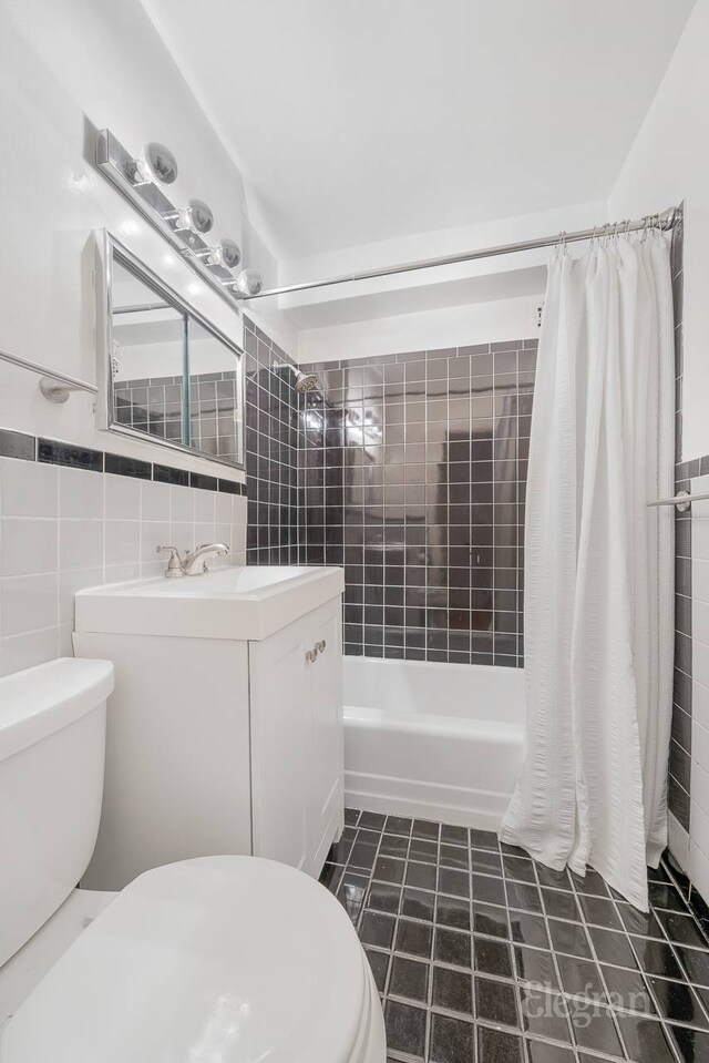 25 W 13th St Unit 6Kn, New York City, NY 10011 - bathroom featuring tile walls, vanity, shower / tub combo, and tile patterned flooring